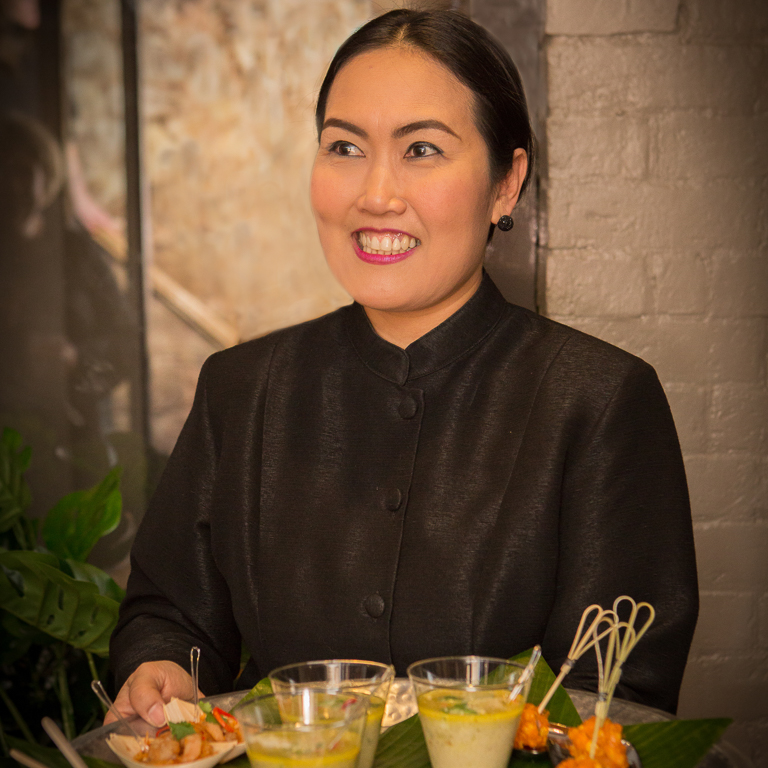Waiter with food and drinks at Giggling Squid Warwick Launch Rebecca Fennell Photography