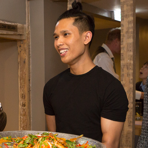 Waiter with large tray of food at the Giggling Squid Farnham Launch Rebecca Fennell Photography