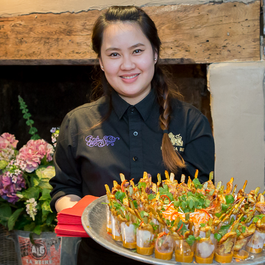 Waiter with food at the Giggling Squid Farnham Launch Rebecca Fennell Photography
